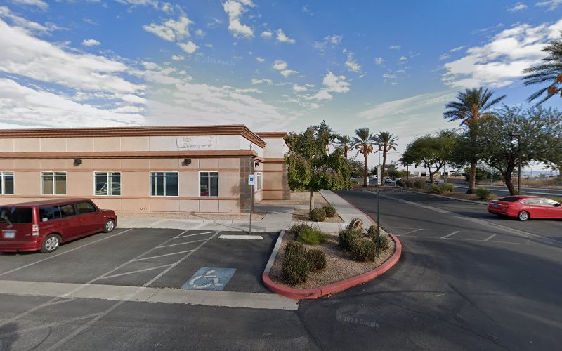Treasure Health System building exterior with tan stucco, parking lot, and desert landscaping