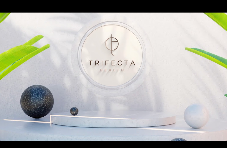Trifecta Health branding displayed on white platform with geometric spheres and green foliage