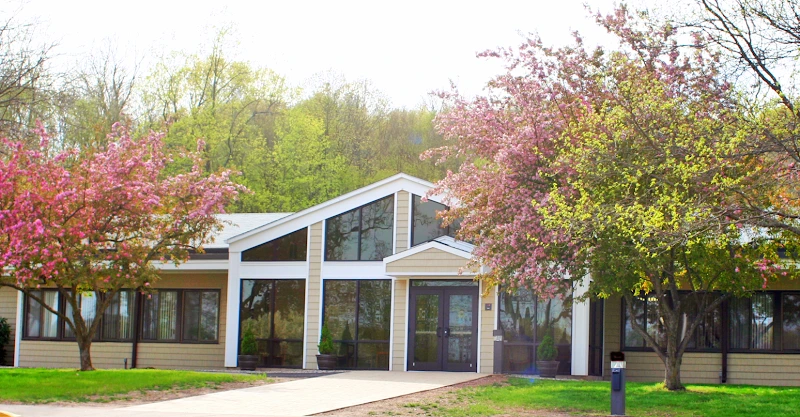 Modern medical office building with white trim and blooming spring trees