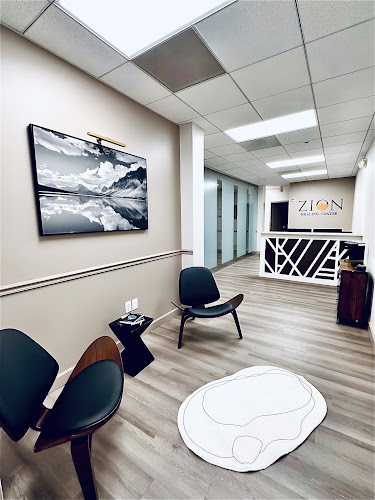 Zion Healing Center reception area with mountain landscape wall art, modern seating, and branded reception desk
