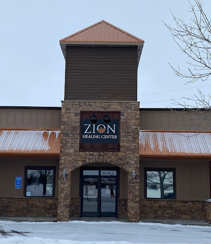 Zion Healing Center brick building exterior with signage and snow on ground