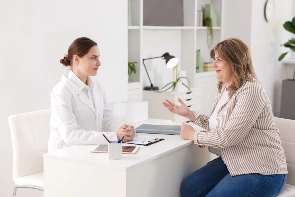 Healthcare provider and patient discussing treatment in clinical office setting
