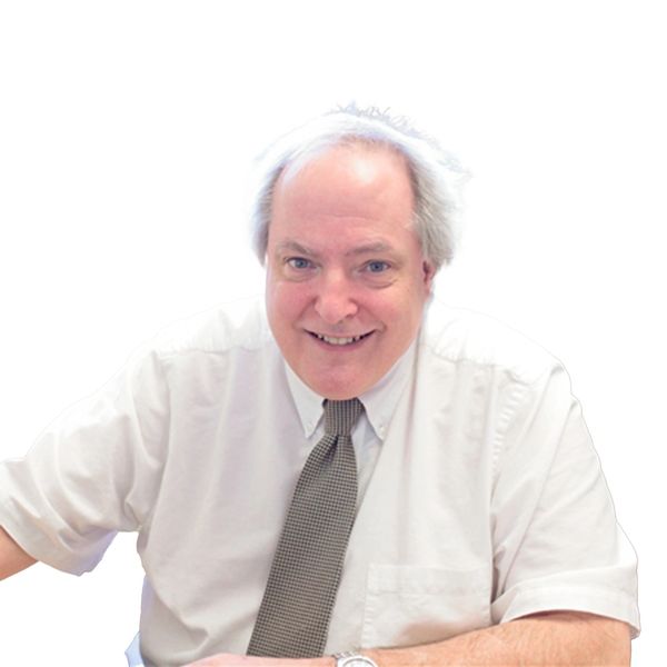 Man in white shirt and gray tie smiling in professional headshot