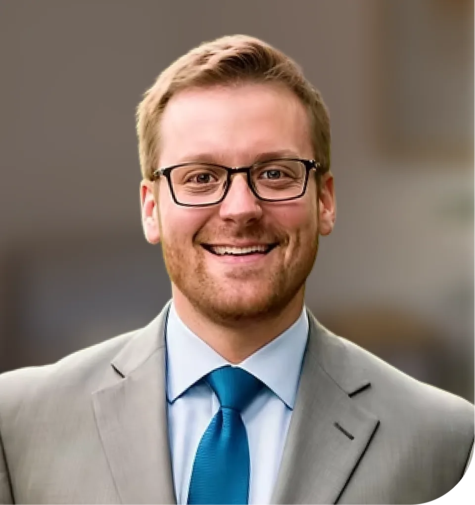 Thomas Martin, man wearing glasses, light blue shirt, and blue tie