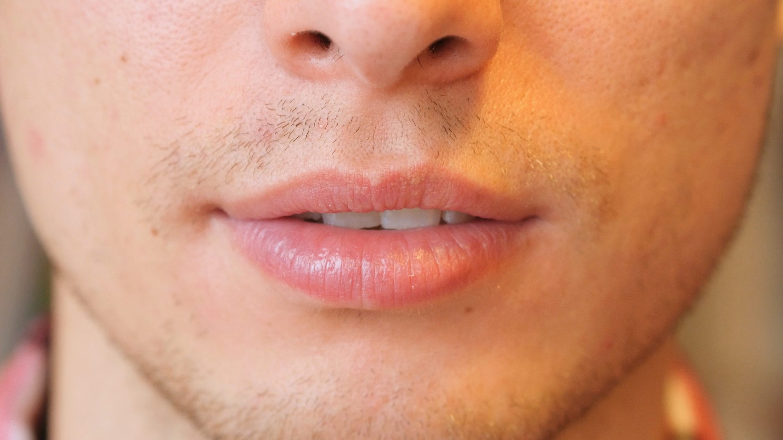 Close-up of man's upper lip and facial hair above mouth