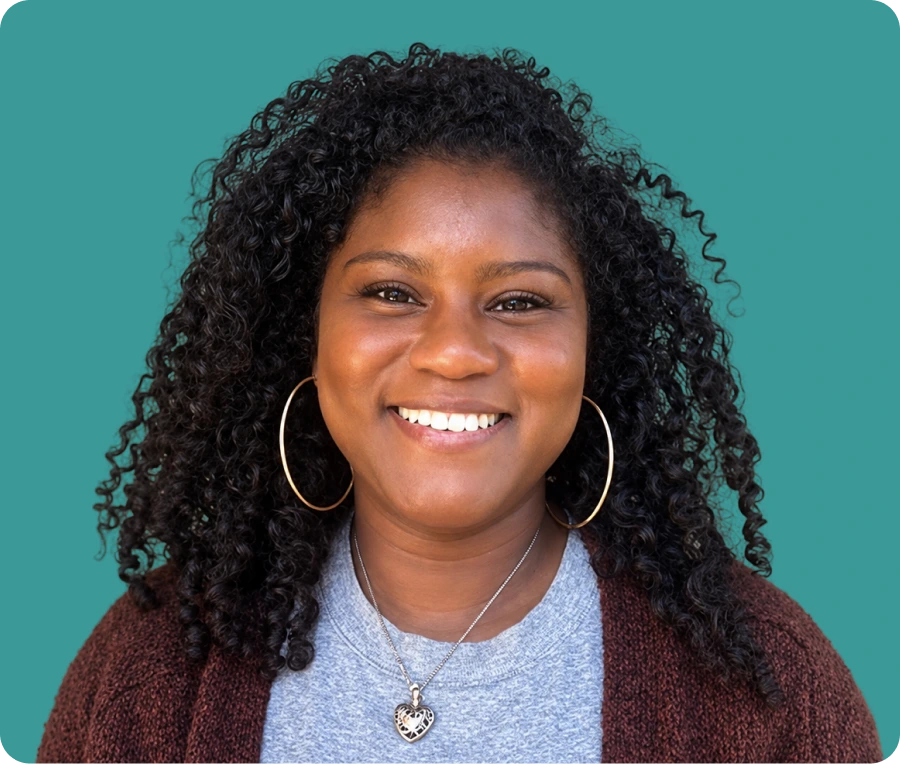 Tanyan, a new team member at Uriel Behavioral Wellness, smiling at the camera against a teal background