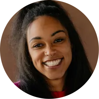 Smiling woman with long dark hair against a brown background