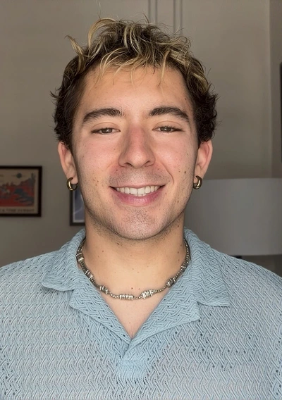 Theo Thompson-Guldseth, a therapist at Vibrant Life Therapy, smiling at the camera