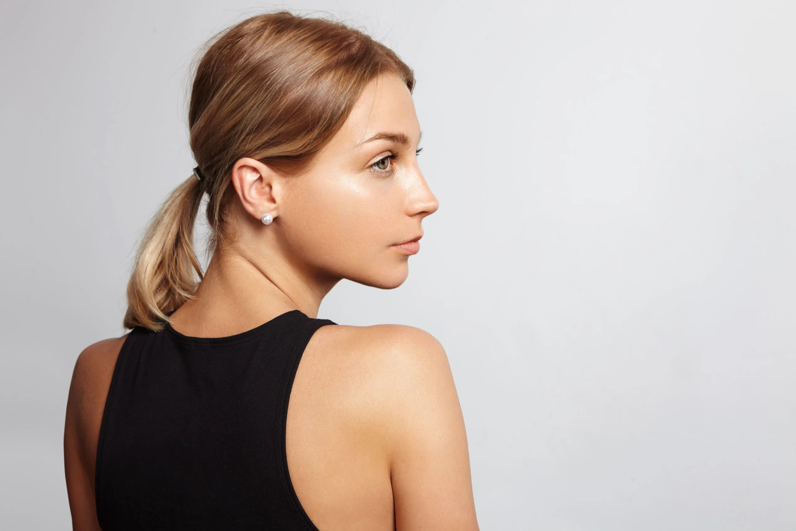 Side profile of a woman with a defined jawline and neck
