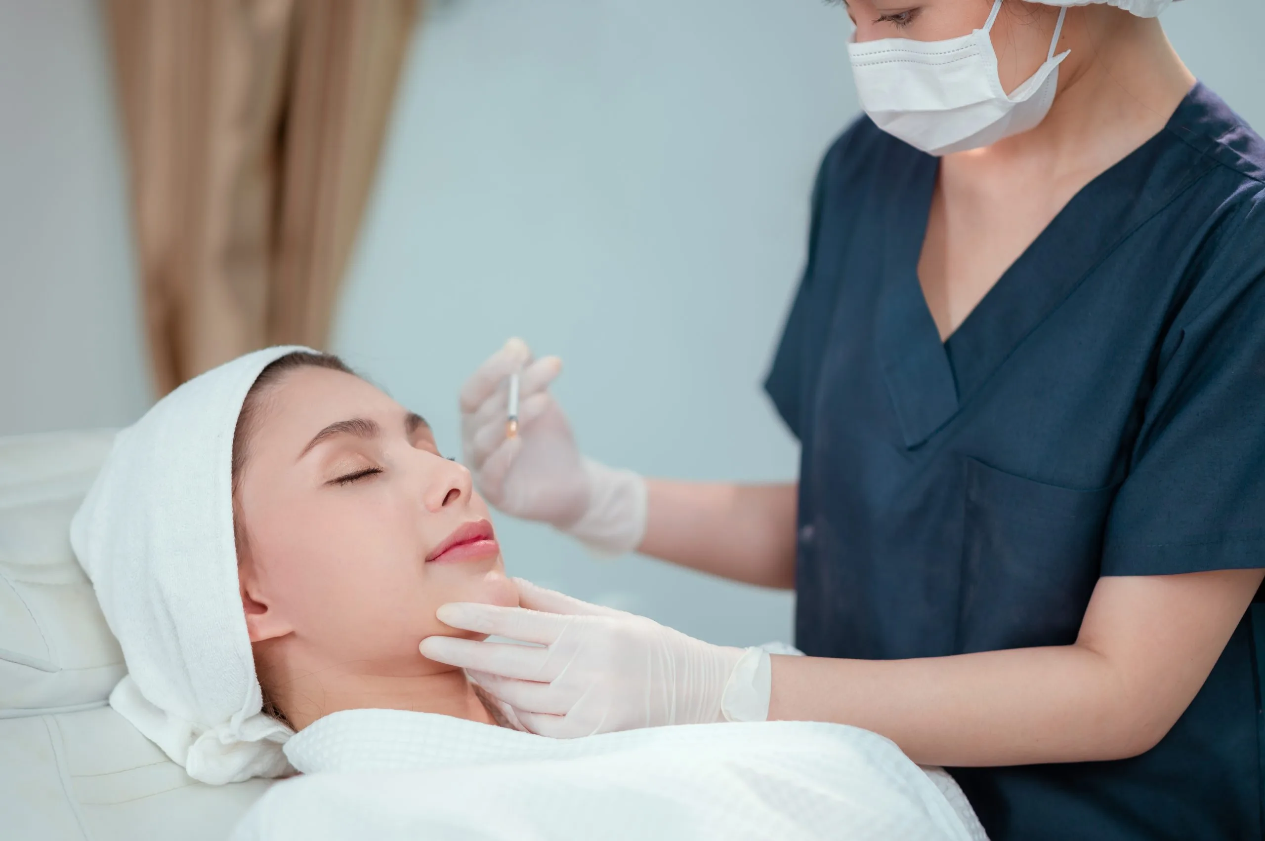Provider injecting Kybella into fat beneath the chin