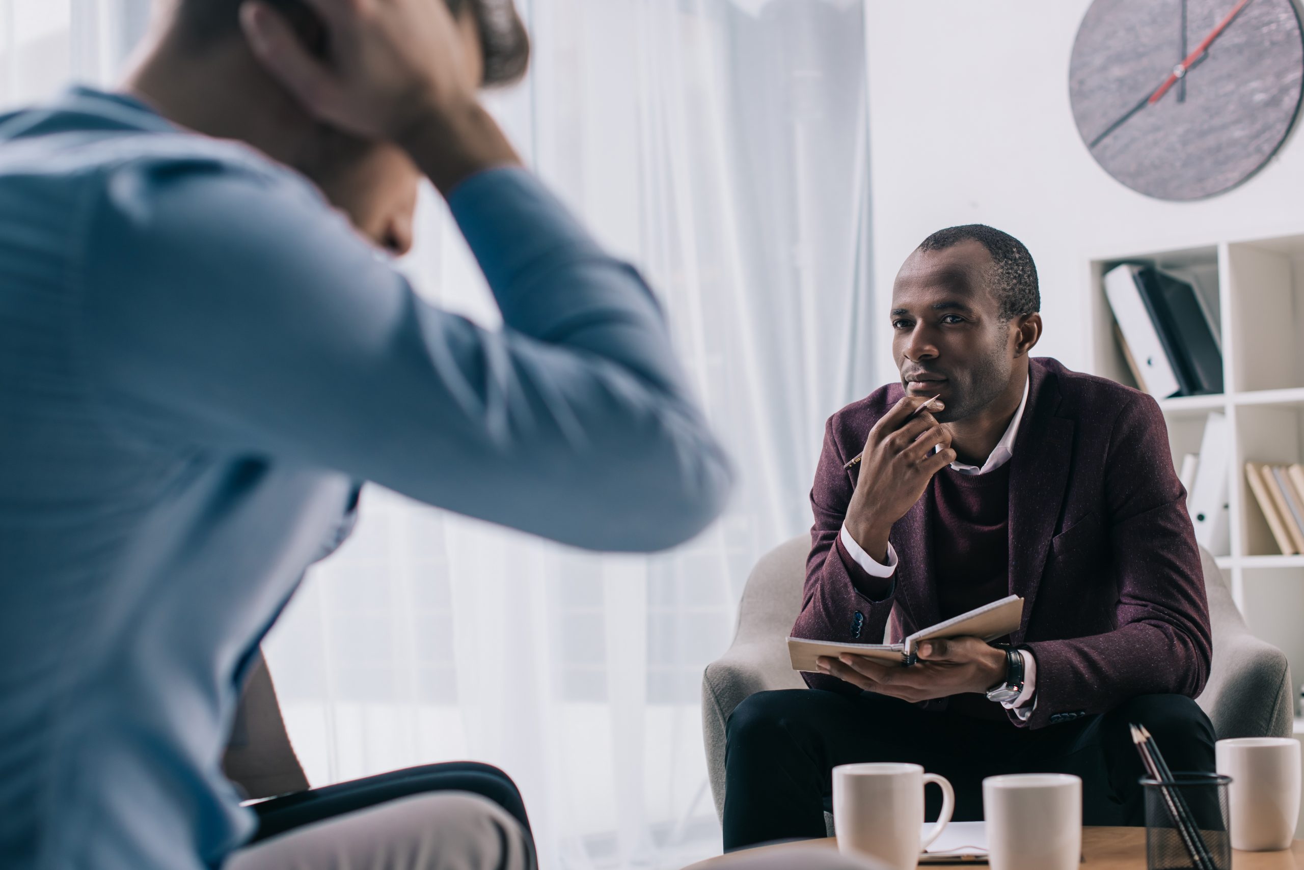 Young man on a sofa speaking with a psychiatrist – psychiatrist in Lafayette, CA