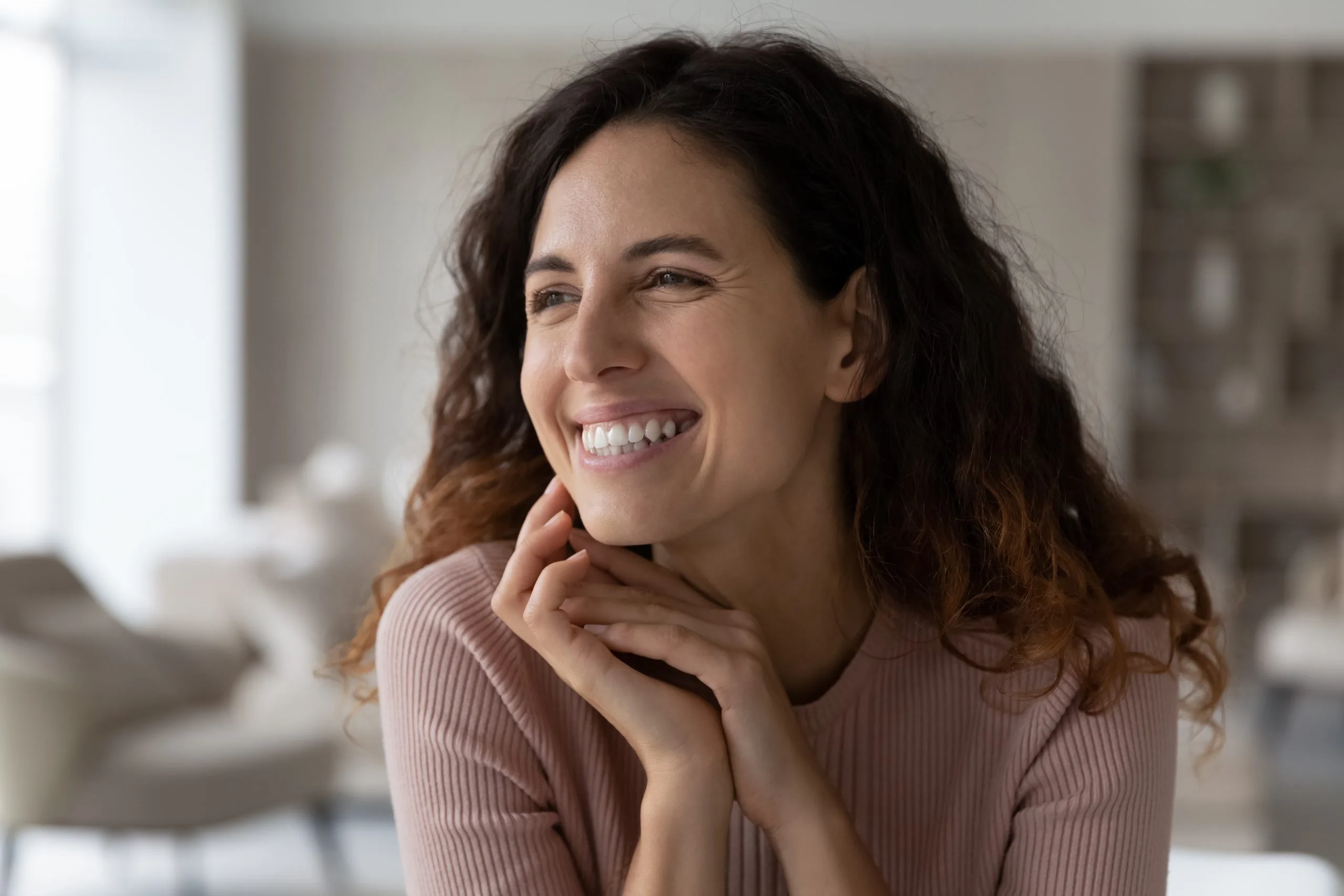 Smiling Hispanic woman looking into the distance – anxiety treatment patient