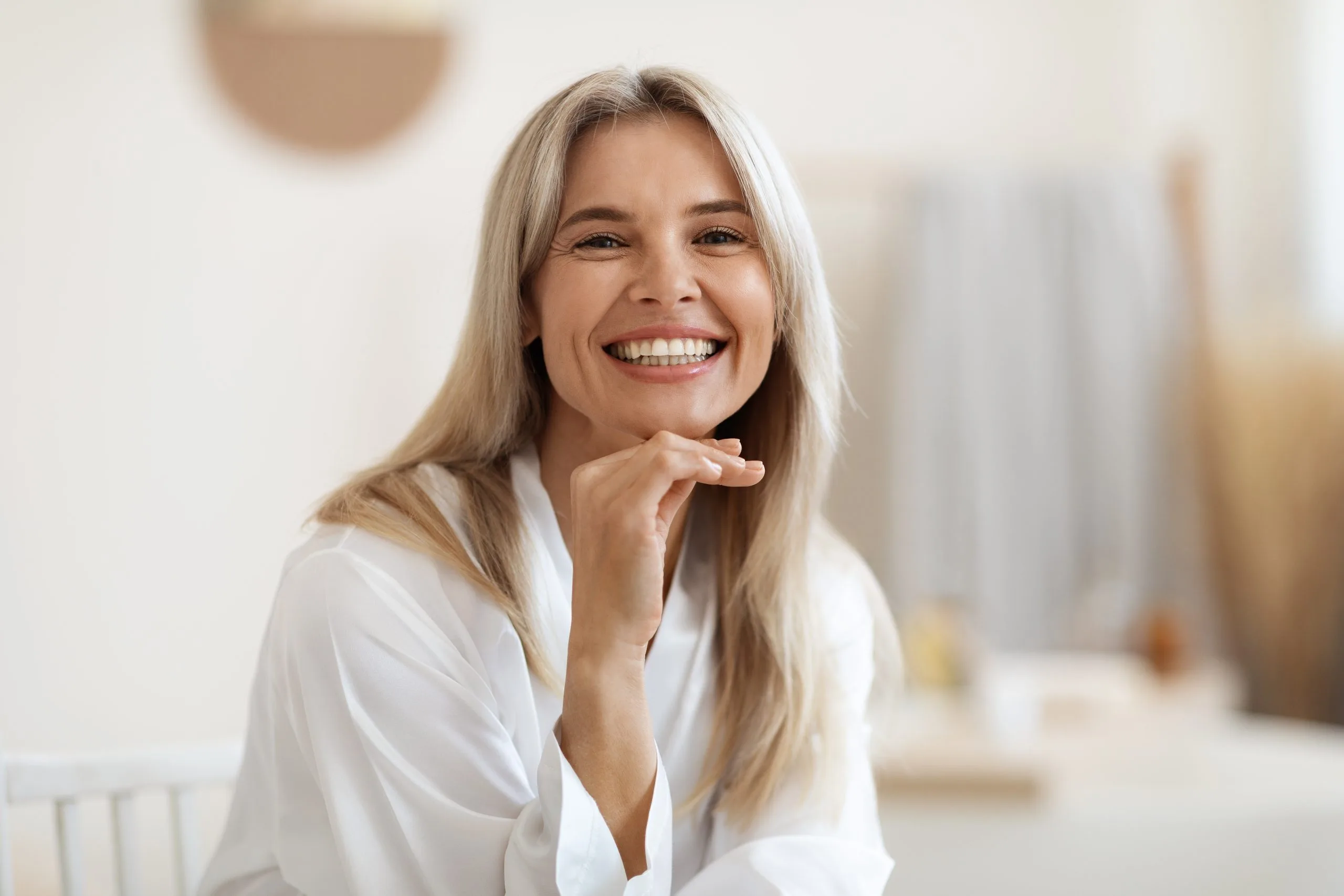 Happy blonde woman relaxing in a white robe – SPRAVATO treatment in Clayton, CA
