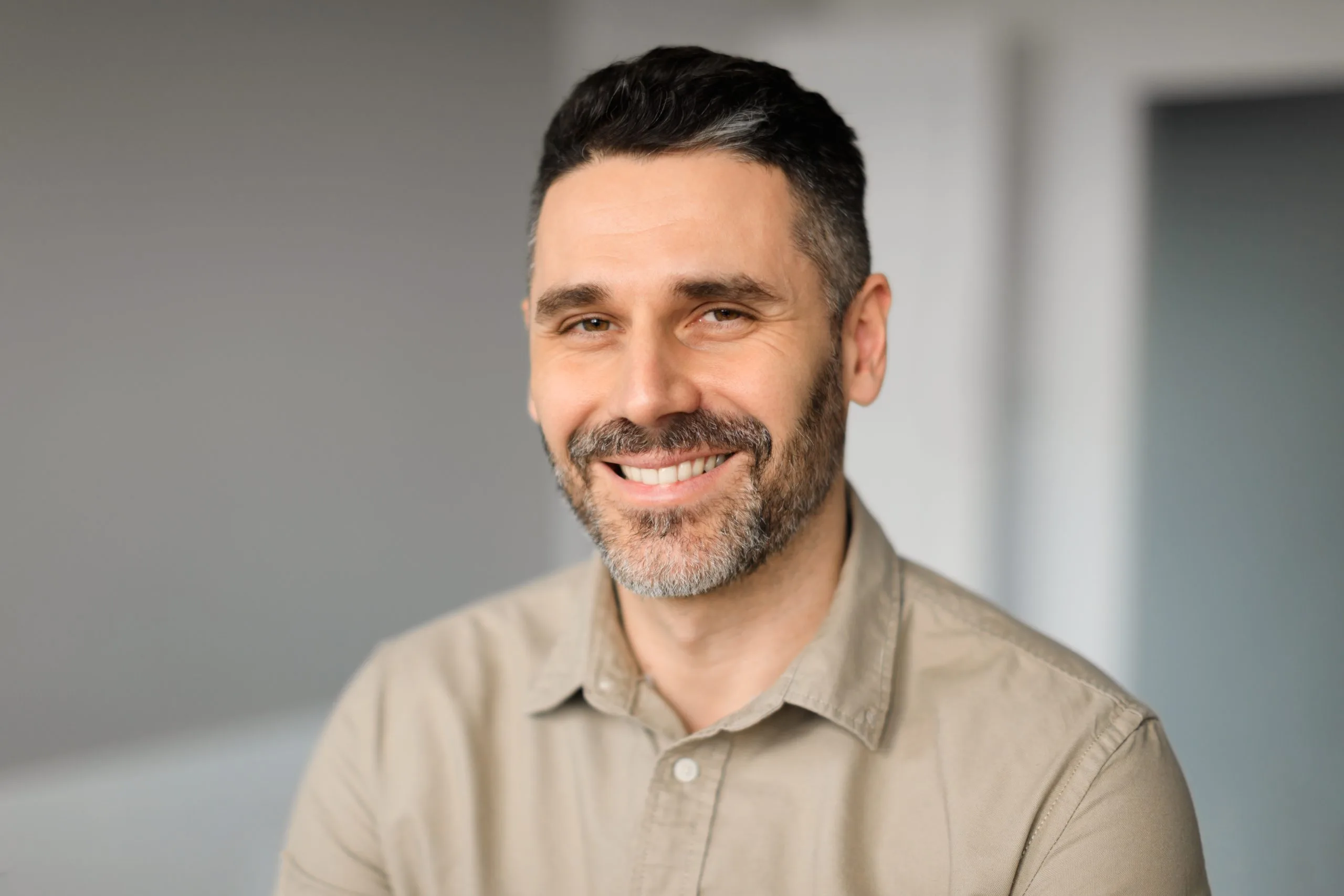 Happy middle-aged businessman working in an office – bipolar disorder treatment patient