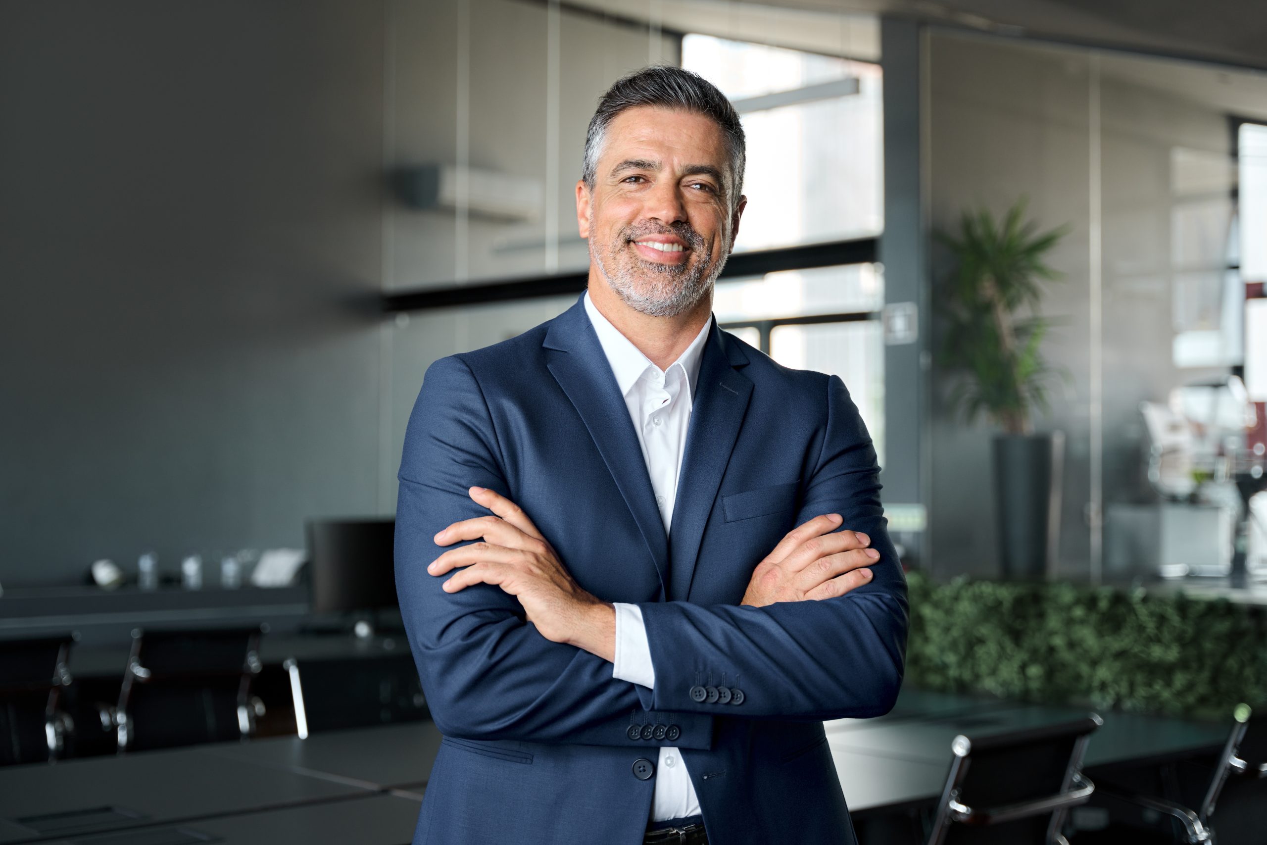 Happy middle-aged businessman standing in an office – SPRAVATO treatment in Livermore, CA