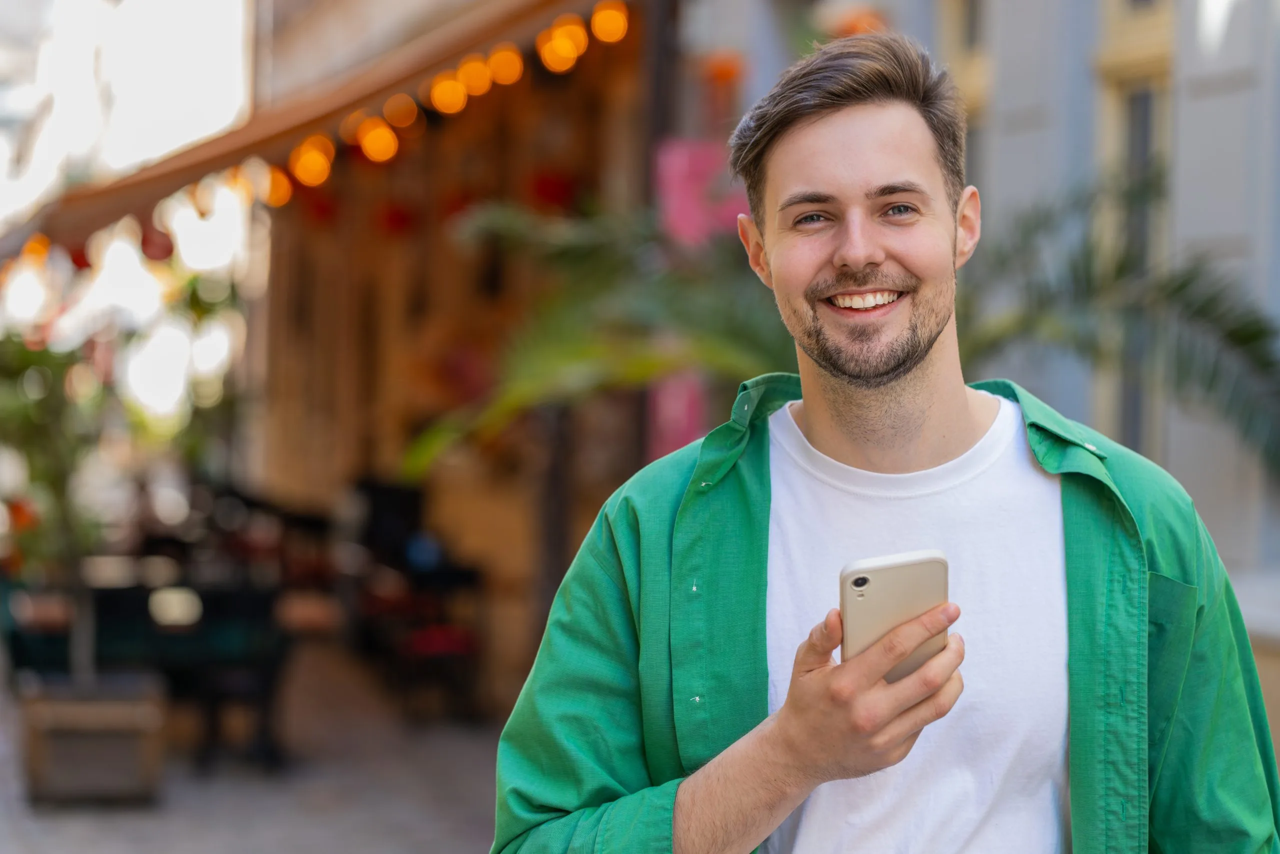 Smiling young man using a smartphone – SPRAVATO treatment in Lafayette, CA