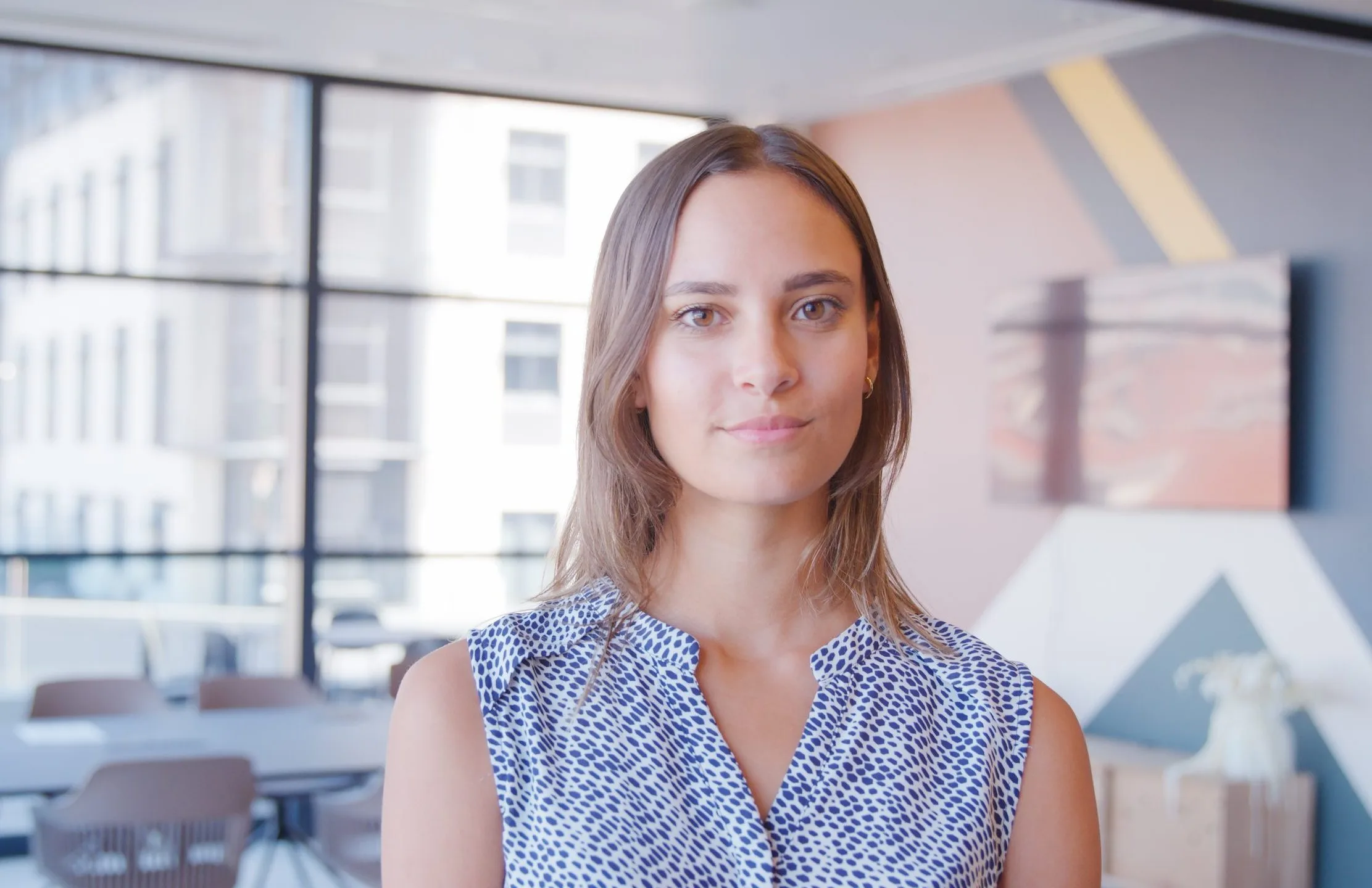 Young businesswoman standing in a modern office – medication management patient
