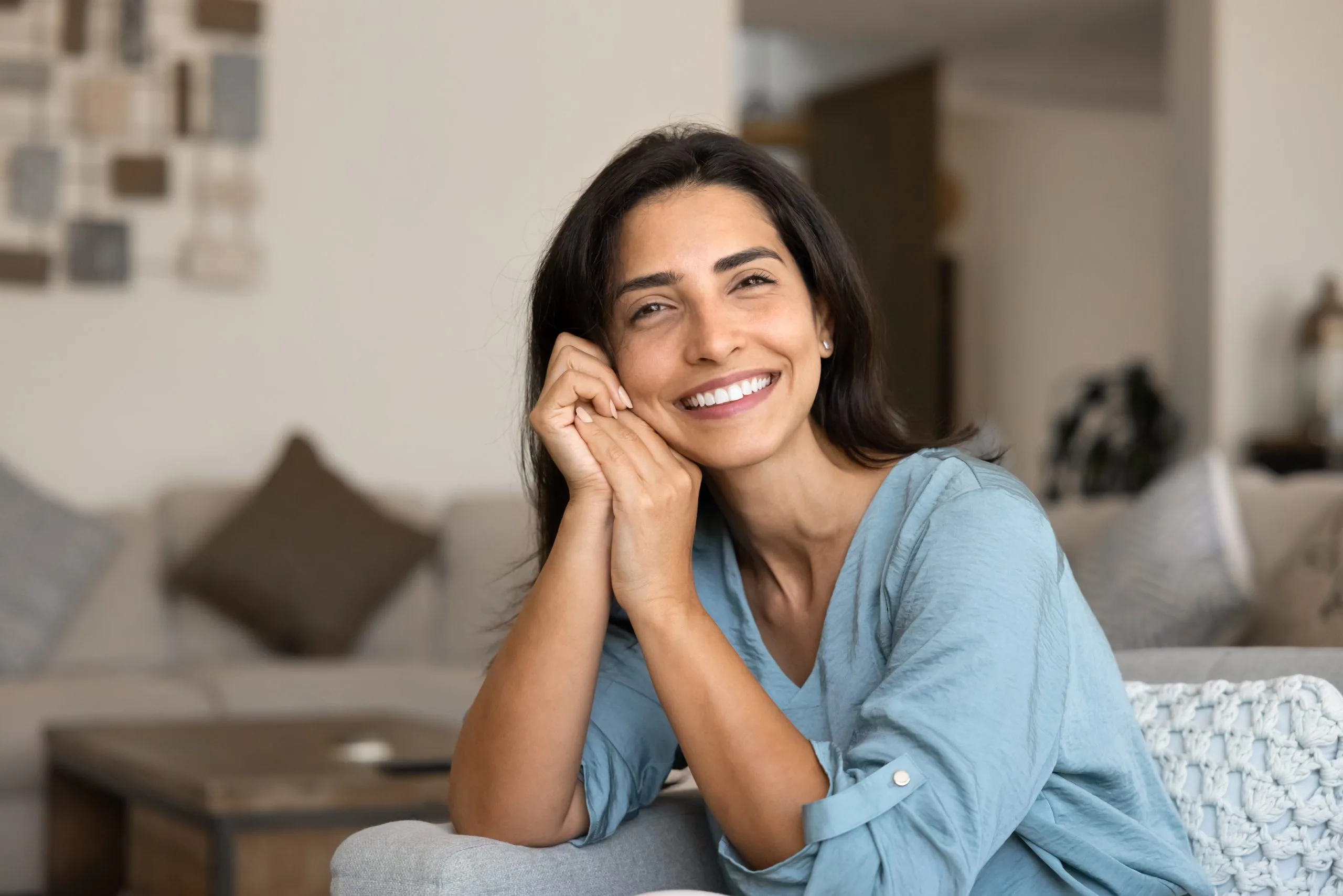 Calm Latina woman sitting comfortably on a cozy sofa – psychiatrist in Pleasanton, CA