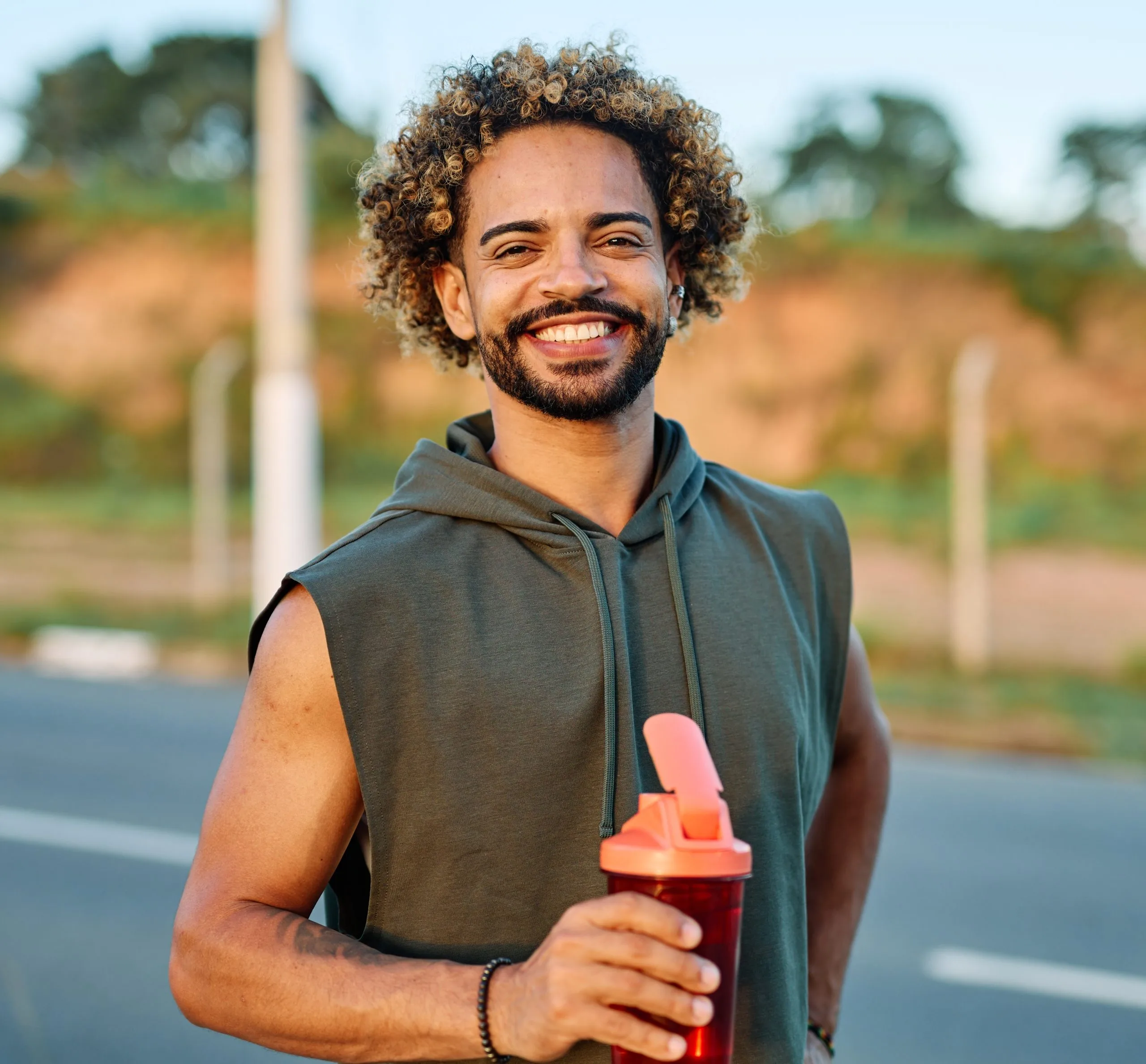 Happy man holding a bottle of water – PTSD and trauma treatment patient