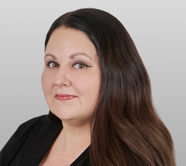 Professional headshot of a woman with dark hair wearing a black top