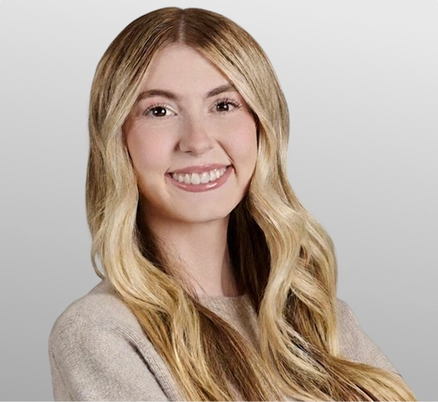 Professional headshot of a woman with blonde hair wearing a beige top