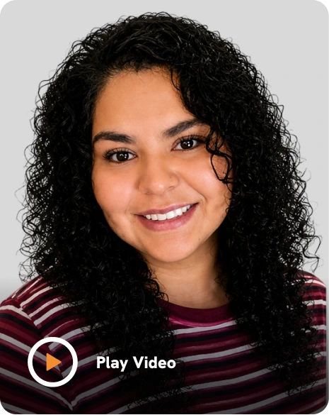 Laura Núñez, Wiser Counseling team member, smiling at camera in striped burgundy shirt