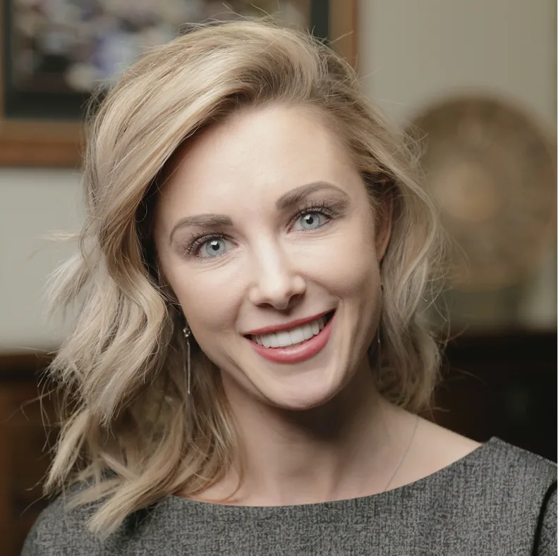 Woman smiling at camera in dental office setting
