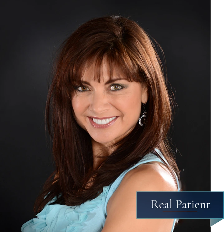 Real Patient: woman with brown hair smiling at camera wearing light blue top