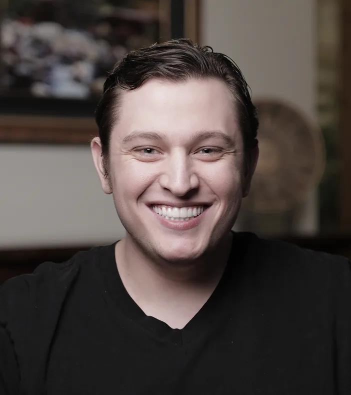 Man smiling broadly at camera displaying white teeth
