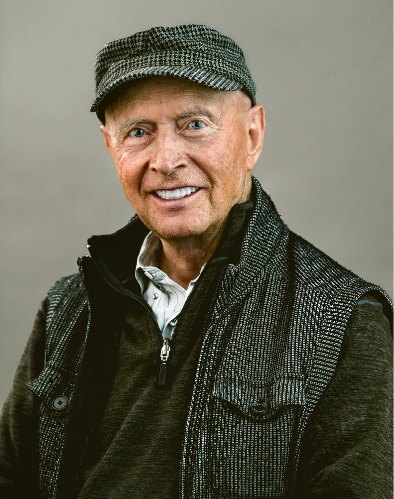 Smiling senior man wearing gray cap and jacket, patient portrait