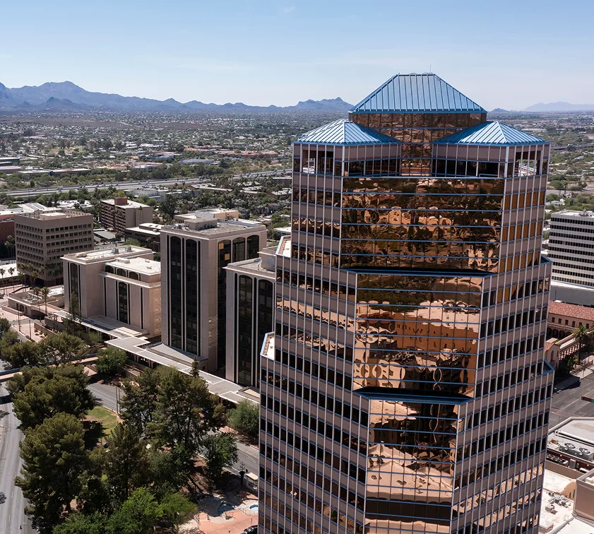 Aerial view of downtown Phoenix skyscrapers with mountains in background