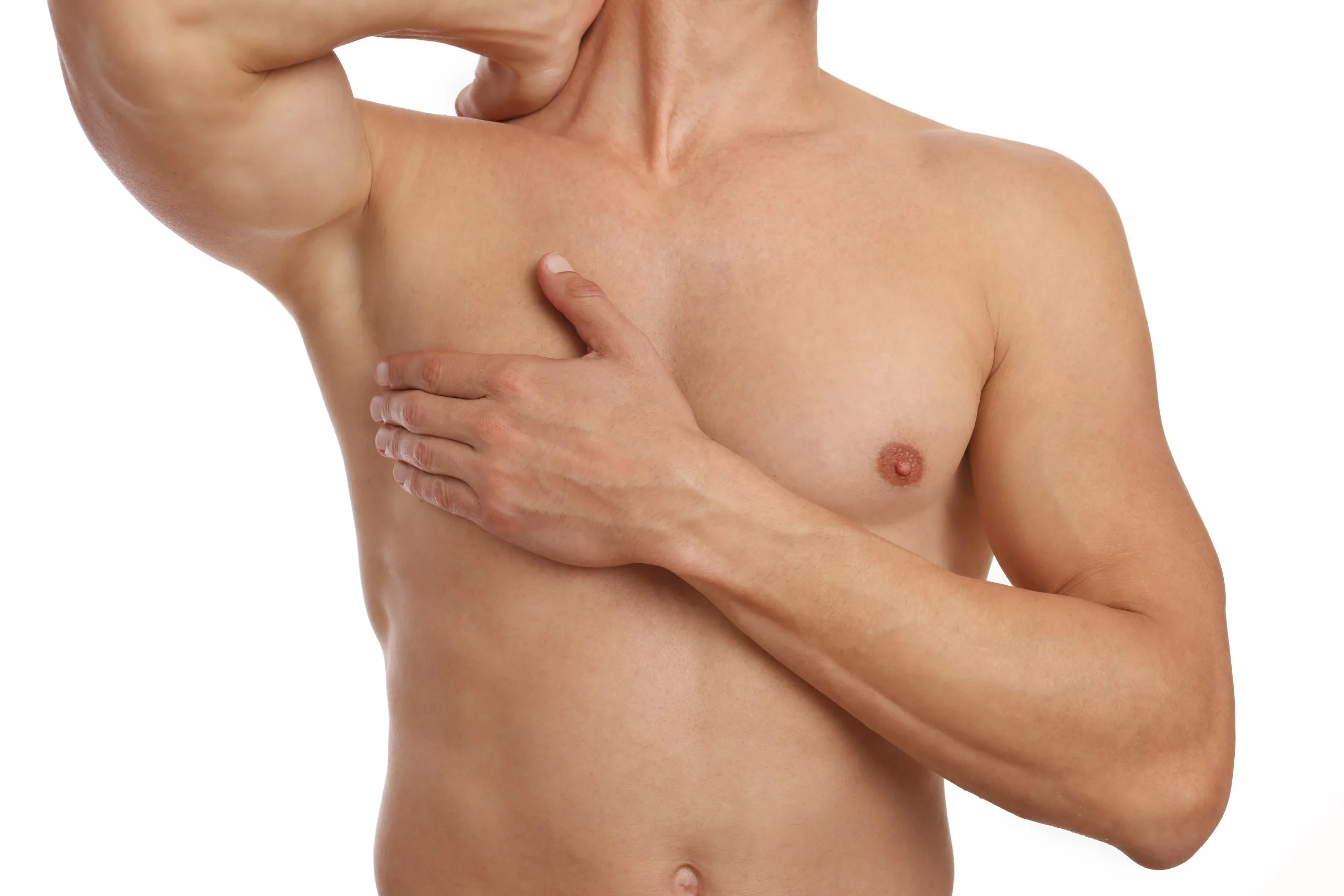 Shirtless man examining his chest with both hands against white background