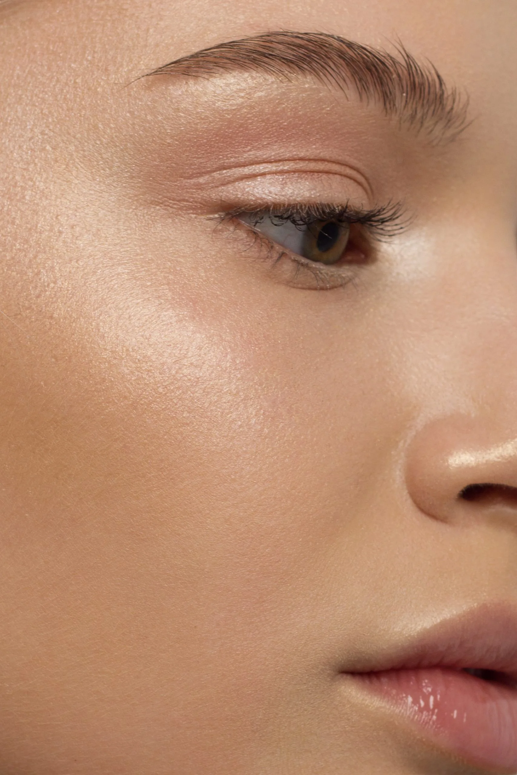 Close-up of woman's eye with defined brow and lashes in profile