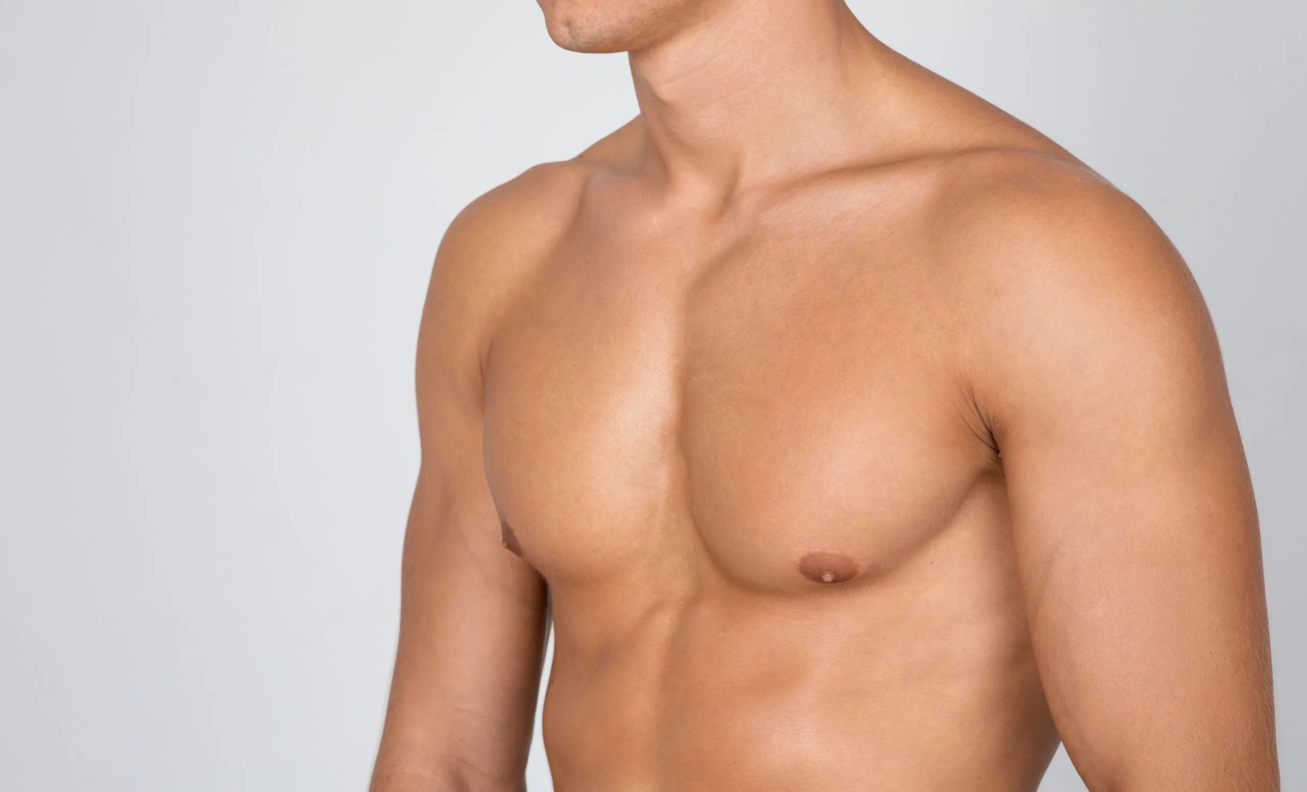 Shirtless man viewed from side showing muscular chest and torso