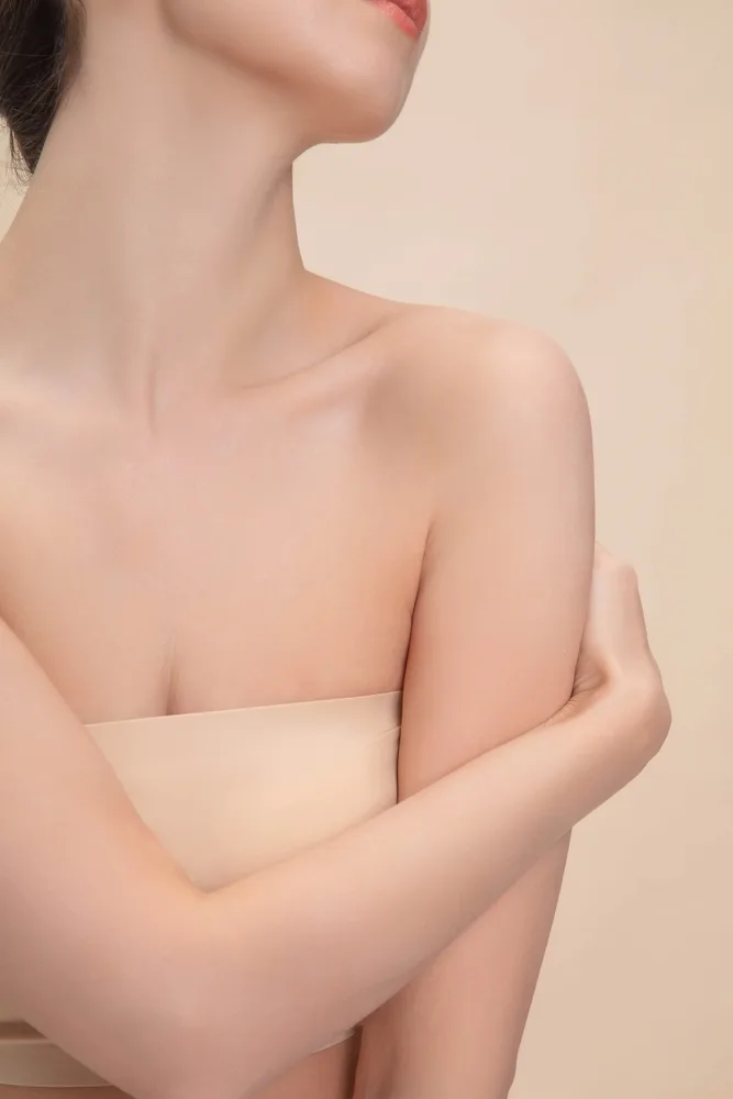 Woman's side profile with torso wrapped, showing breast and neck area