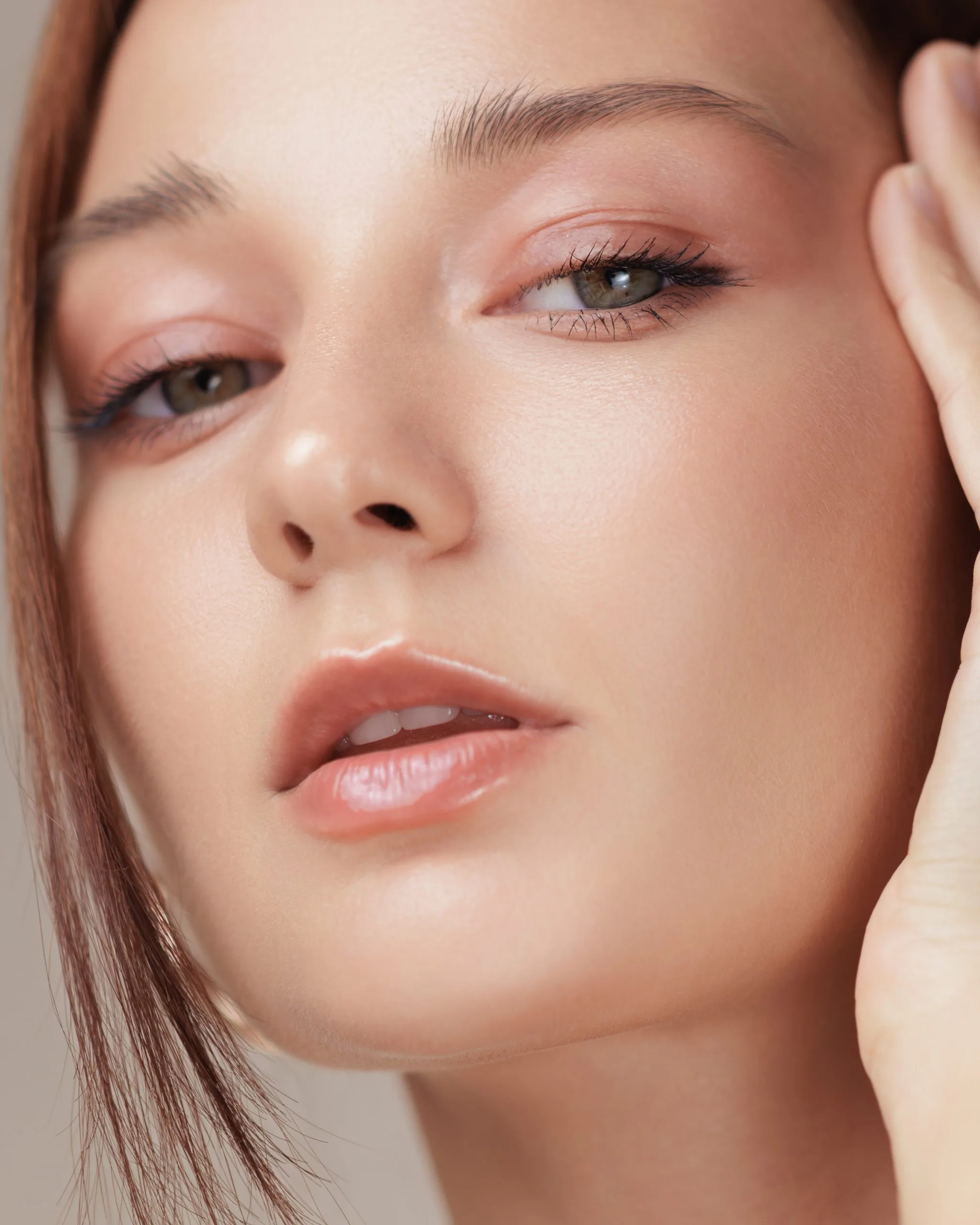 Close-up of woman's face showing eyes, nose, and lips with subtle makeup