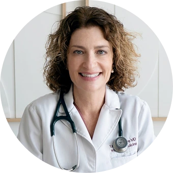 Female physician wearing white coat and stethoscope, portrait headshot