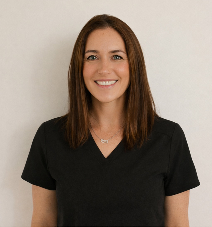 Woman with brown hair smiling, wearing black v-neck shirt